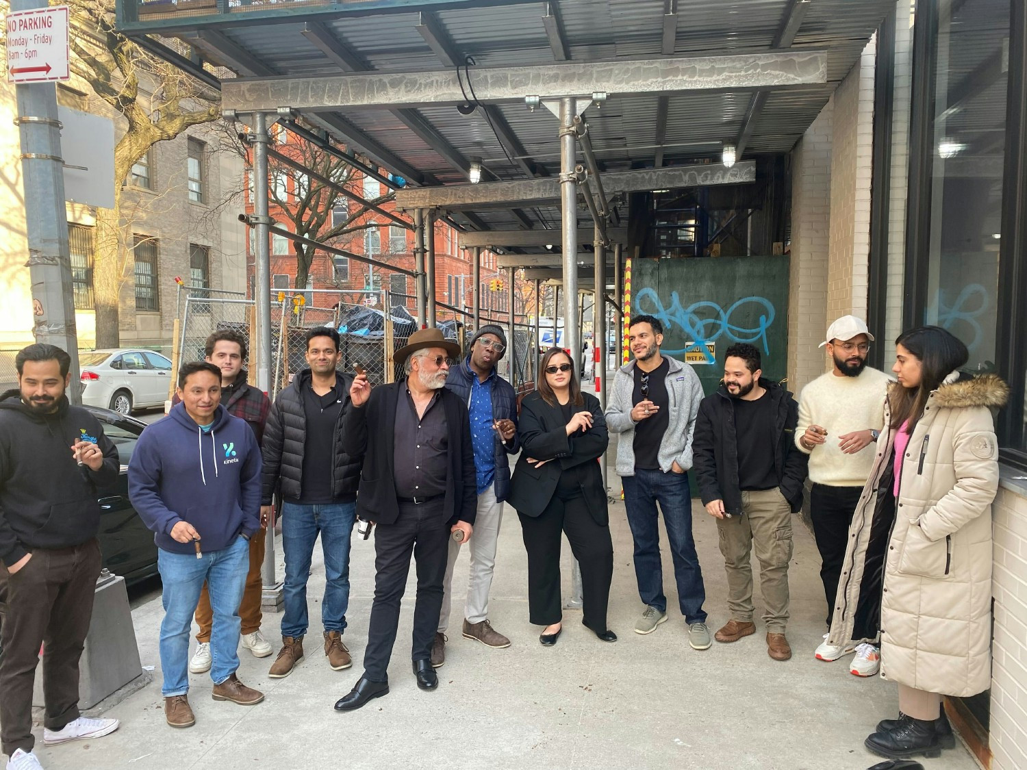 A few team members gather for some cigars with our client outside the office. 