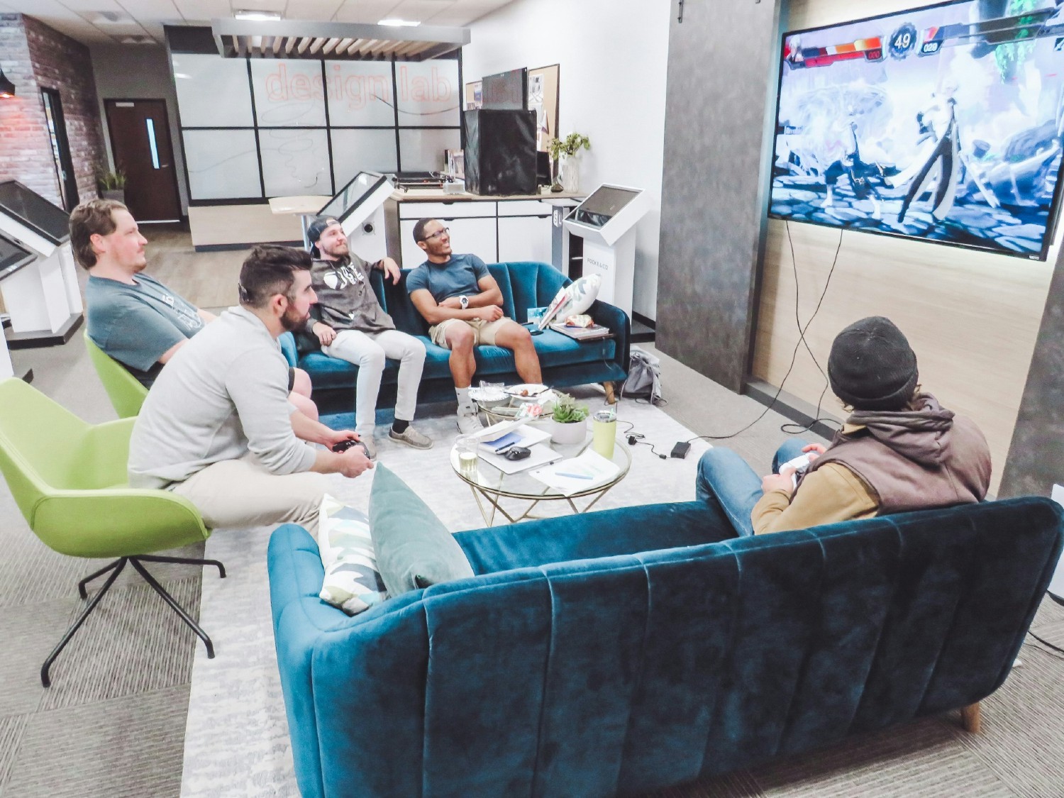 Our service team playing video games in our designed Living Room.