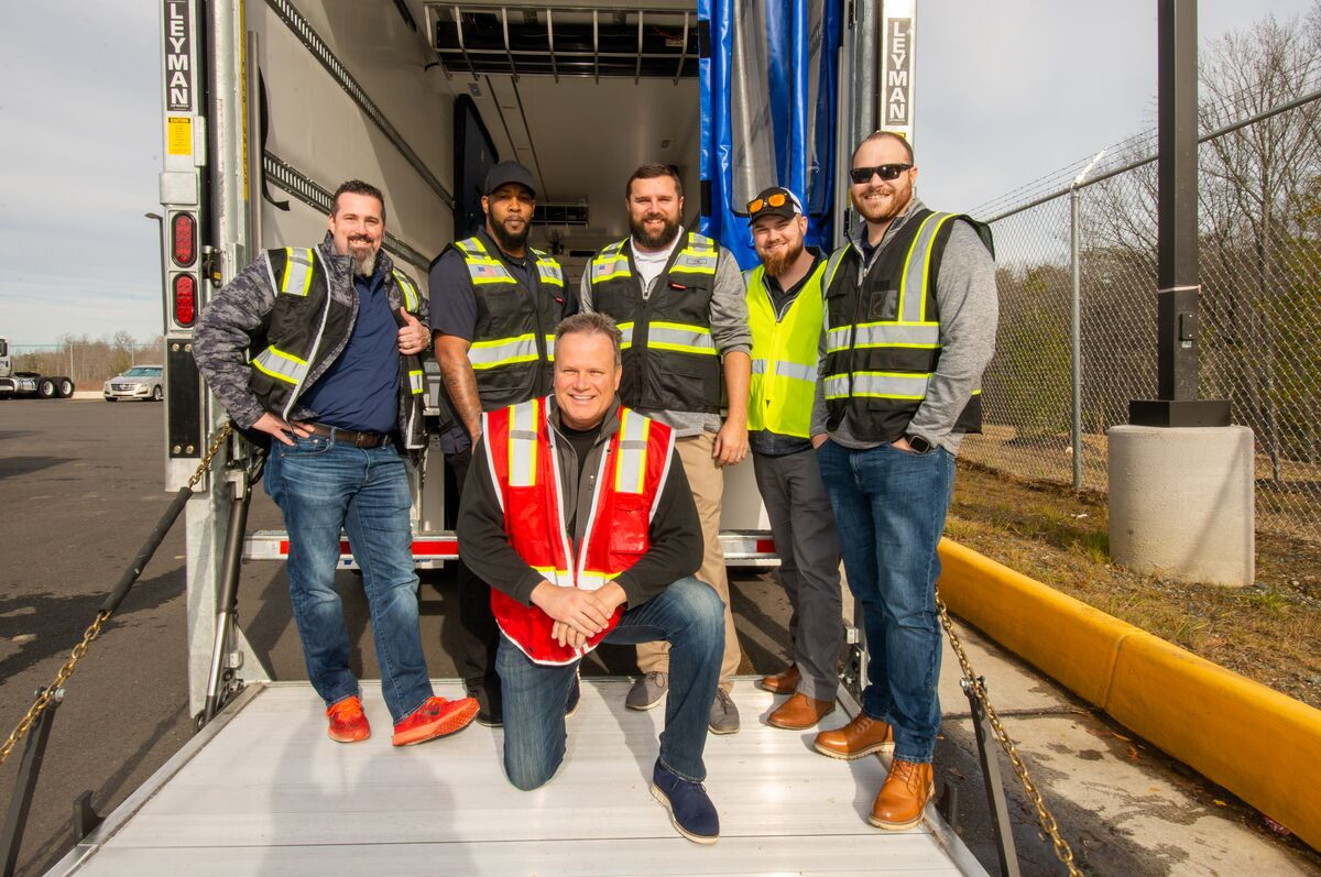 Teams from the Cold Storage group help with delivery and setup of a refrigerated storage trailer.