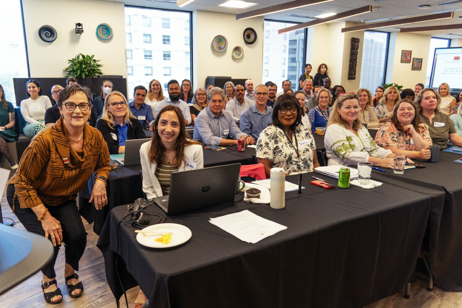 Founder, Board Chair, and President Emeritus Betsy Bassan and the home office at Panagora’s 2024 mid-year review.