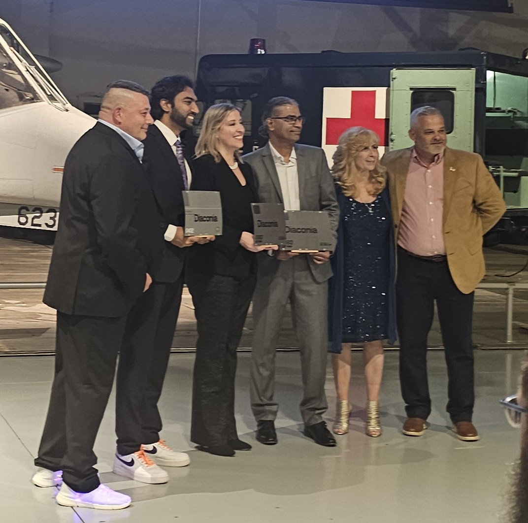 Diaconia's Air Force Mobility team presenting 3 of the visiting executives with custom awards at the holiday party.