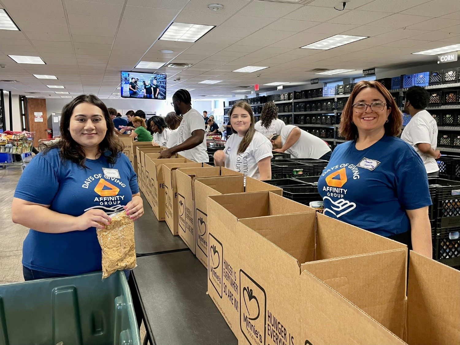 Midwest Team packing lunches to help feed their local community. 