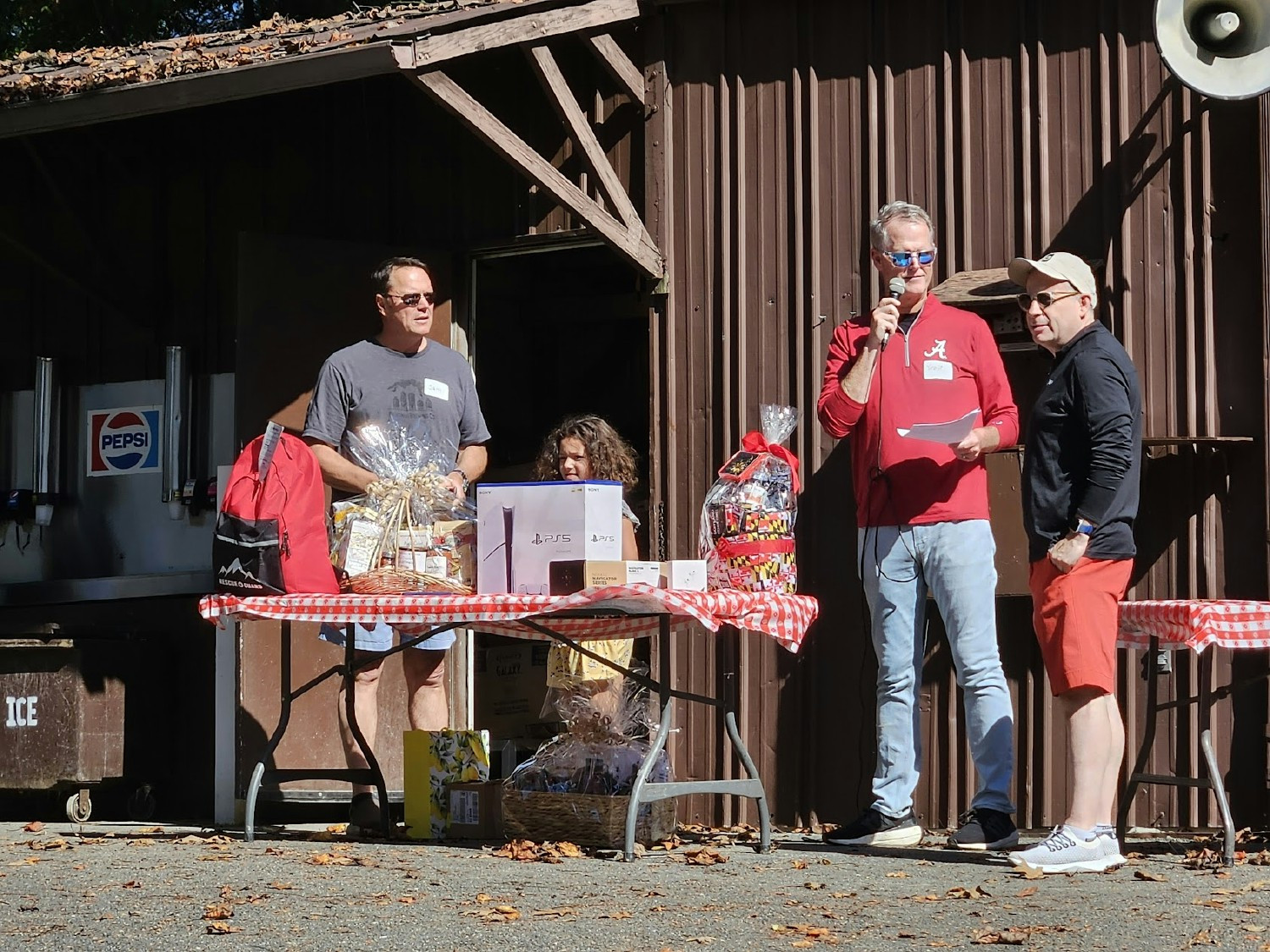 Our Leadership team conducting a prize raffle during our annual company picnic