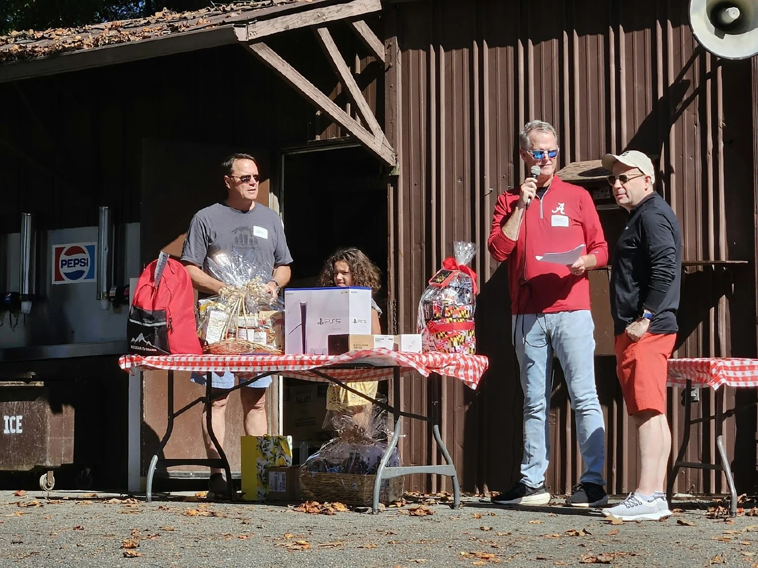 Our Leadership team conducting a prize raffle during our annual company picnic