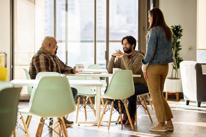 Human Interest's CTO collaborating with colleagues at the San Francisco headquarters. 