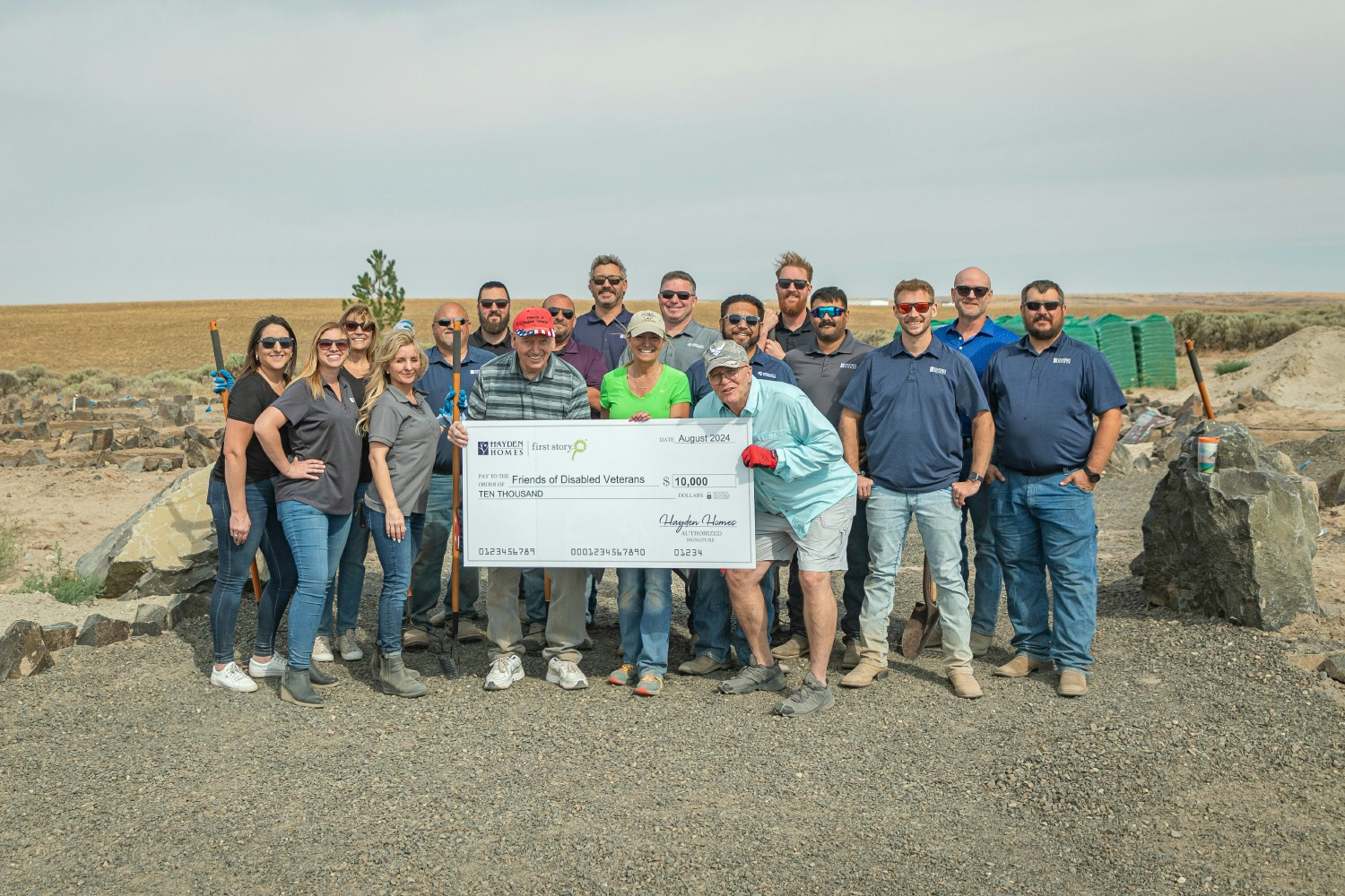 Team members delivering a Frist Story Grant check to after spending a day helping to build trails at their facility. 