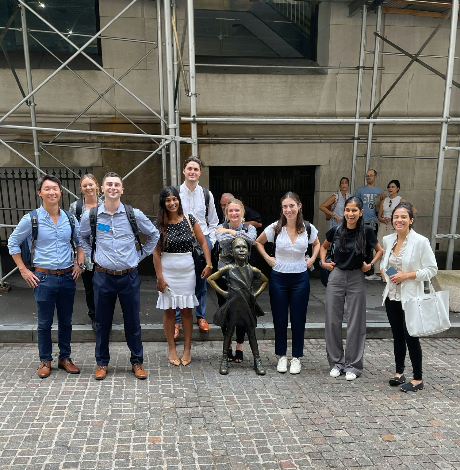 Gilmartin first year analysts posing with The Fearless Girl statue during a visit to the New York Stock Exchange.