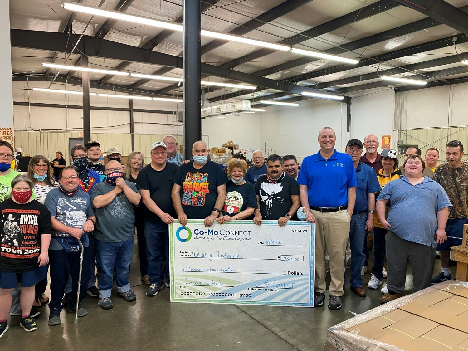 Co-Mo Marketing Coordinator Gene McCoy and Quality Industries workers during a Connect to Help donation presentation.
