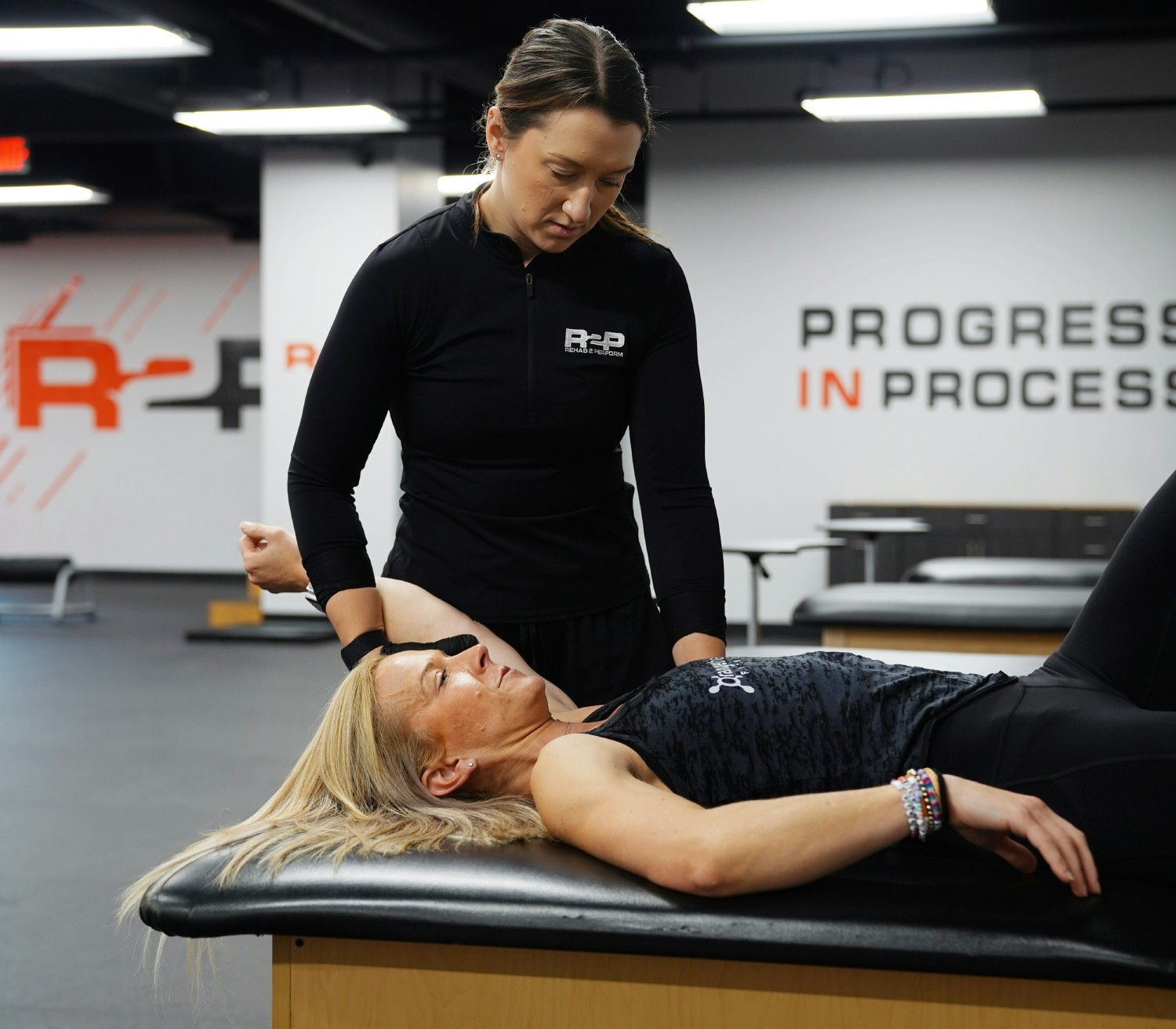 Dr. Paula checking range of motion during an assessment of a patient. 