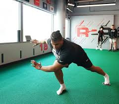 Patient moving on the turf during a physical therapy session.