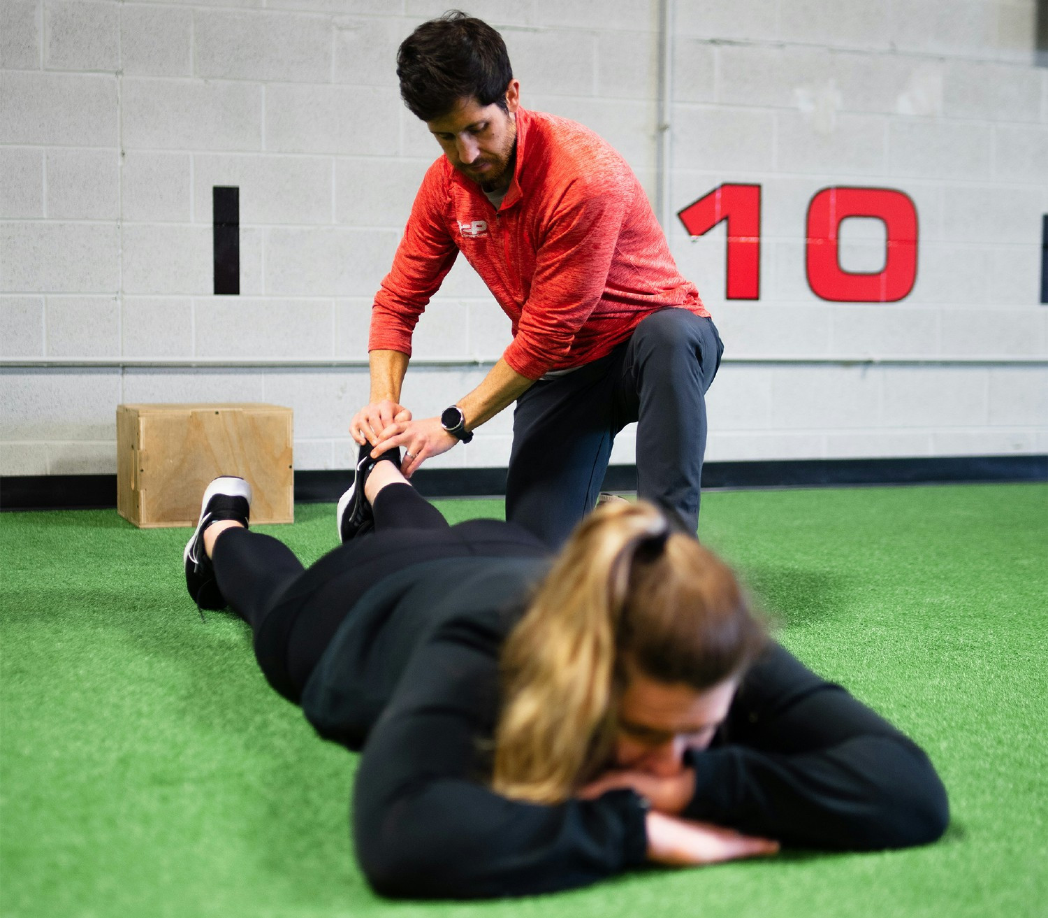Dr. Greg doing an assessment of a patients lower leg during a physical therapy session. 