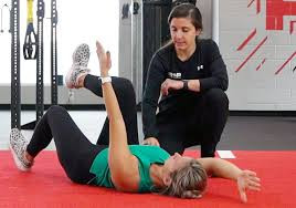 Physical therapist observing a patient performing movement during a session. 