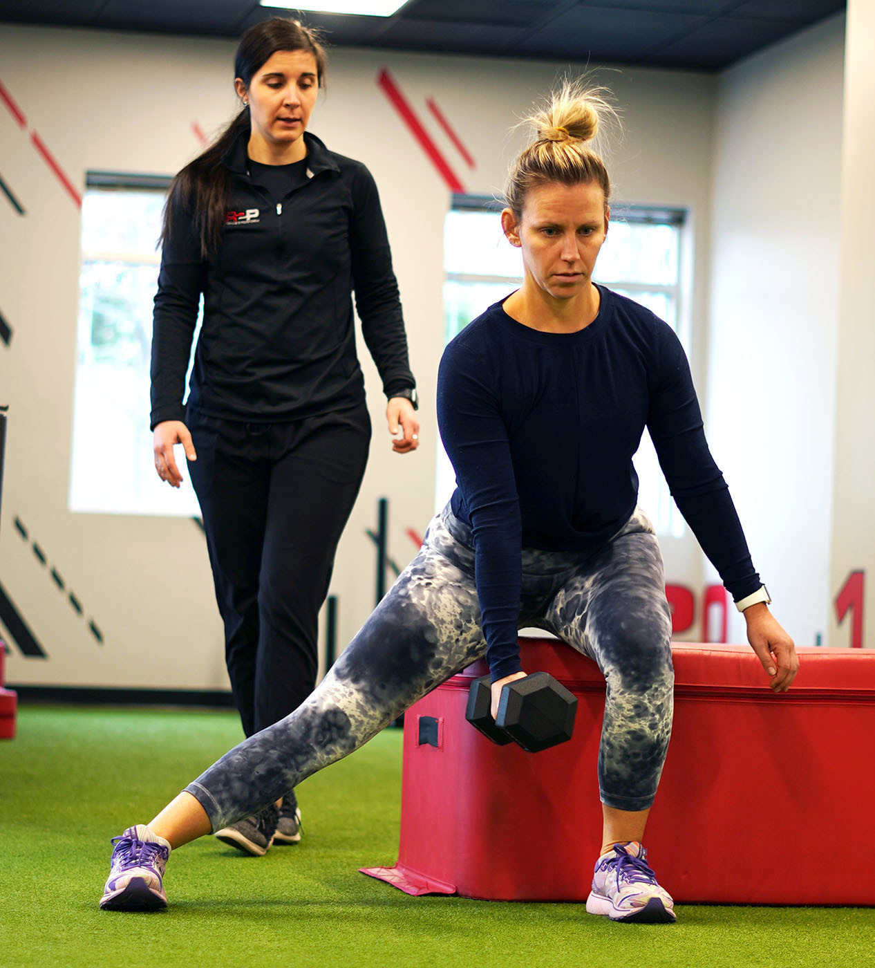 Dr. Jamie observing a patient go through later stage sports rehabilitation session. 