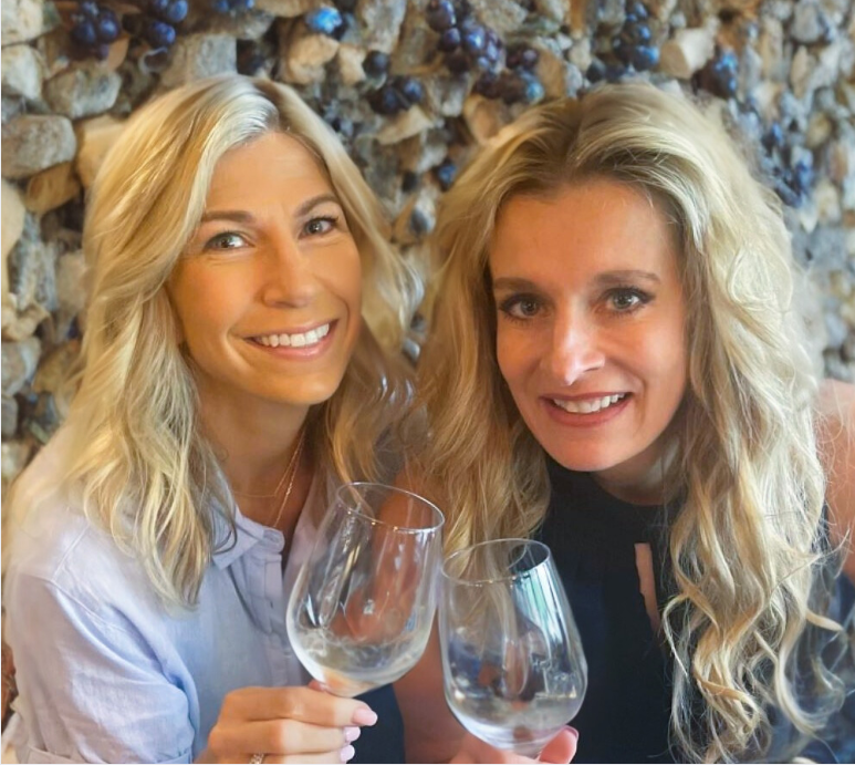 Founders and principals, April Lickovitch and Kimberly Erwin raise a glass to our remarkable staff. 