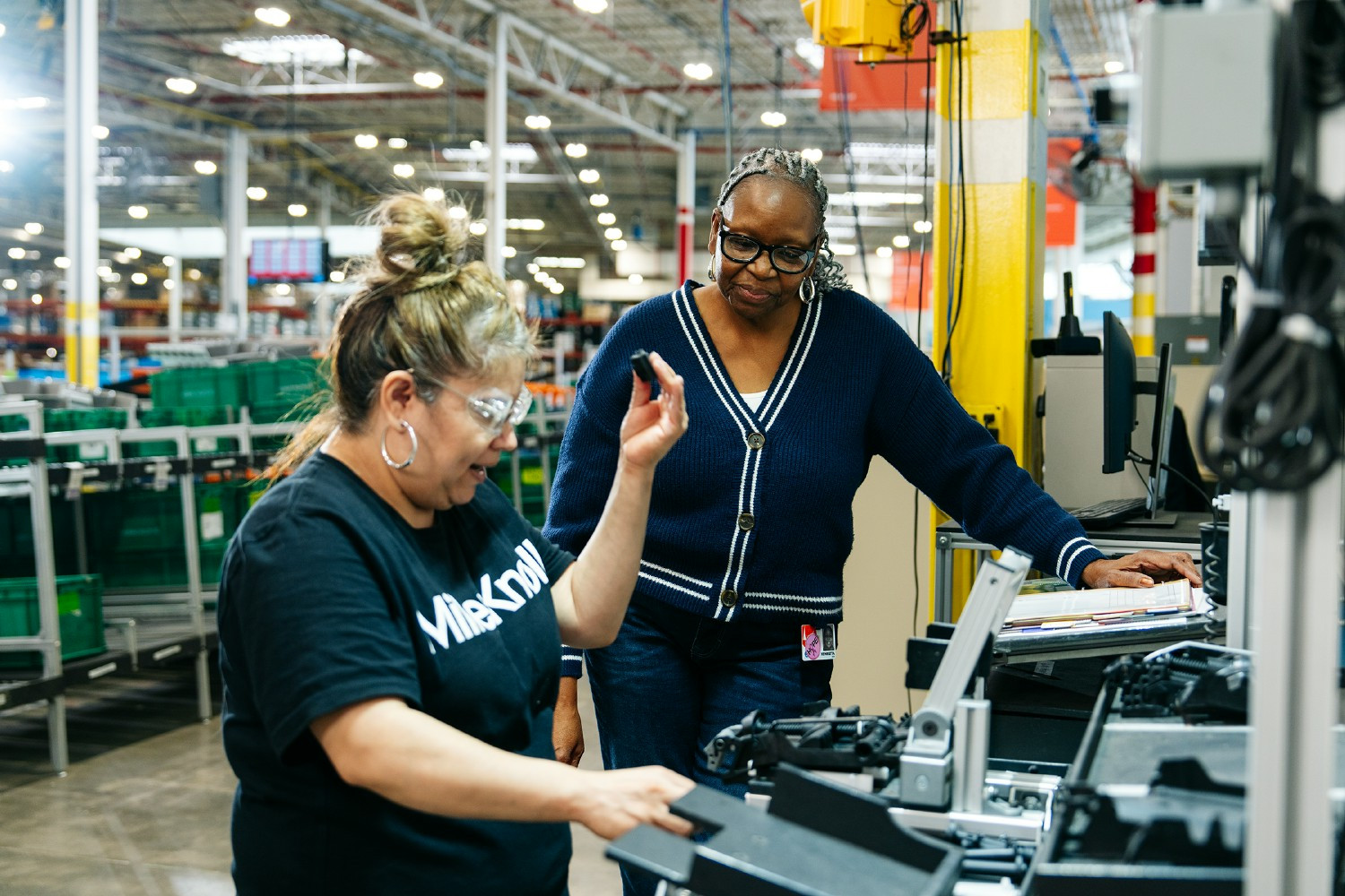 Operations employees collaborating together at a MillerKnoll facility.