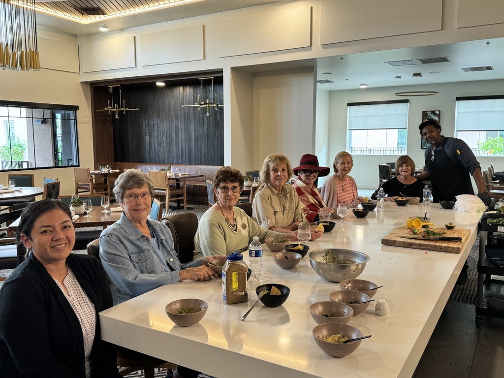 Team members and residents enjoy their time together. This chef-led cooking demo was a fun event for all. 