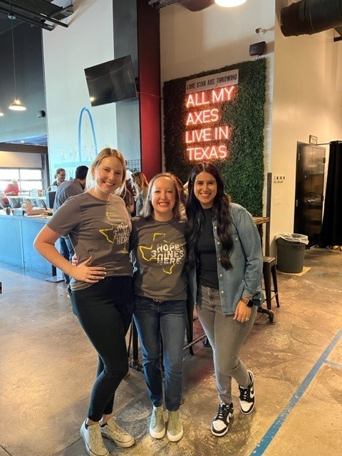 The Dallas team enjoys the first quarter team building event throwing axes. 