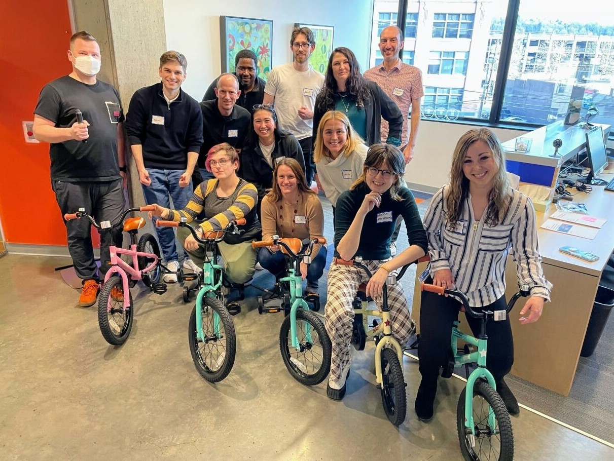 Logicians gather for a Consulting Day volunteer activity, assembling bikes for children ahead of the new school year.