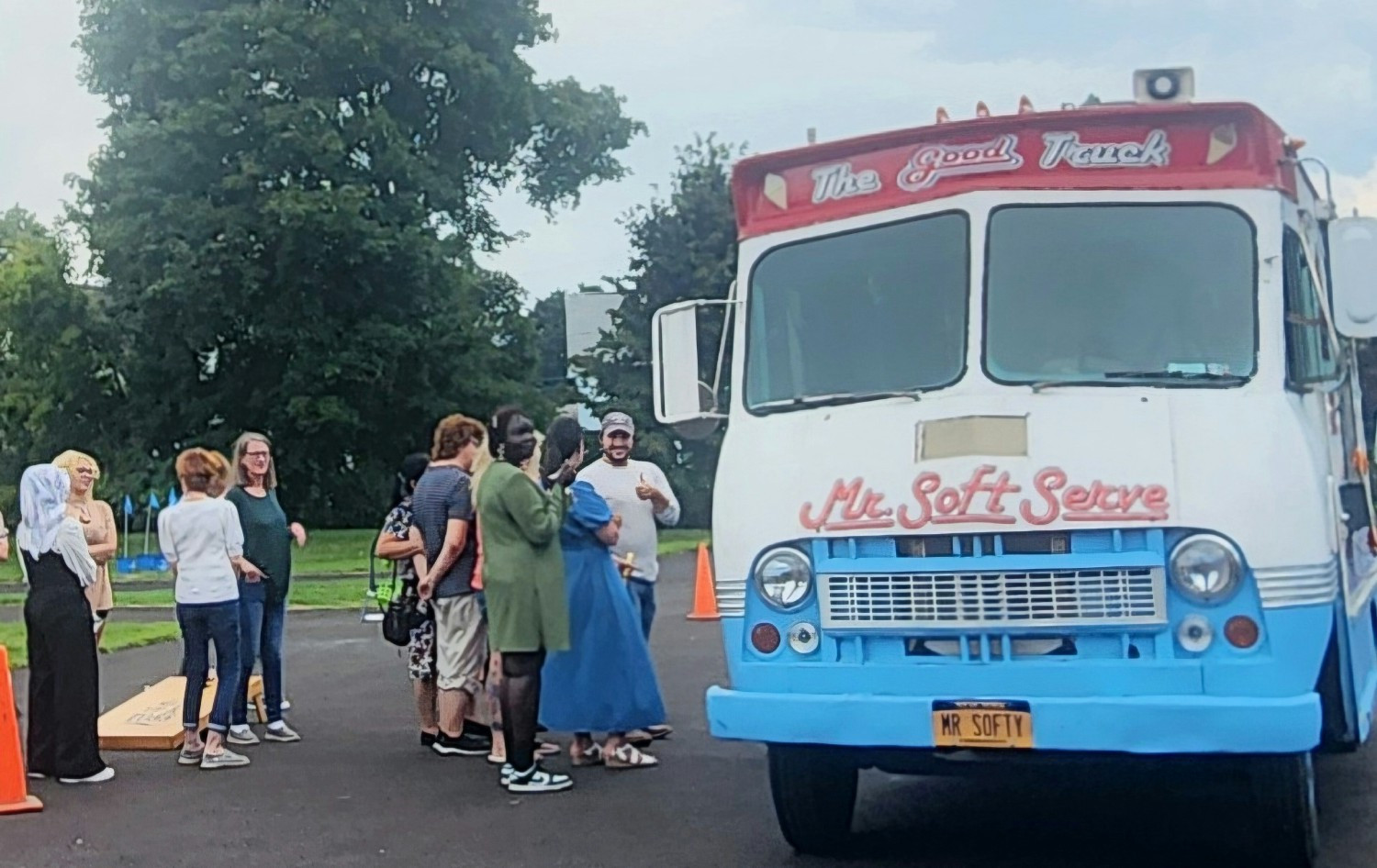 Team members savoring a refreshing treat from the ice cream truck on a warm summer day.