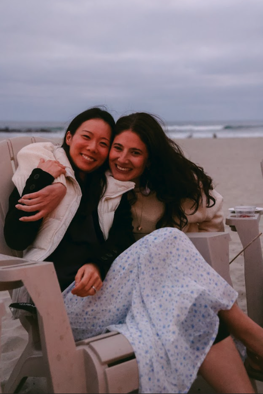 Grace Weingard, President, and Jess Jacobs, CEO, hanging at team beach bonfire