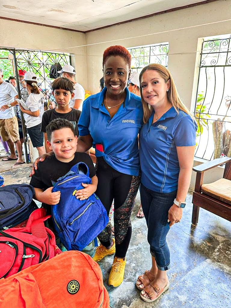 Inspired team members providing school supplies to disadvantaged children in the Caribbean.