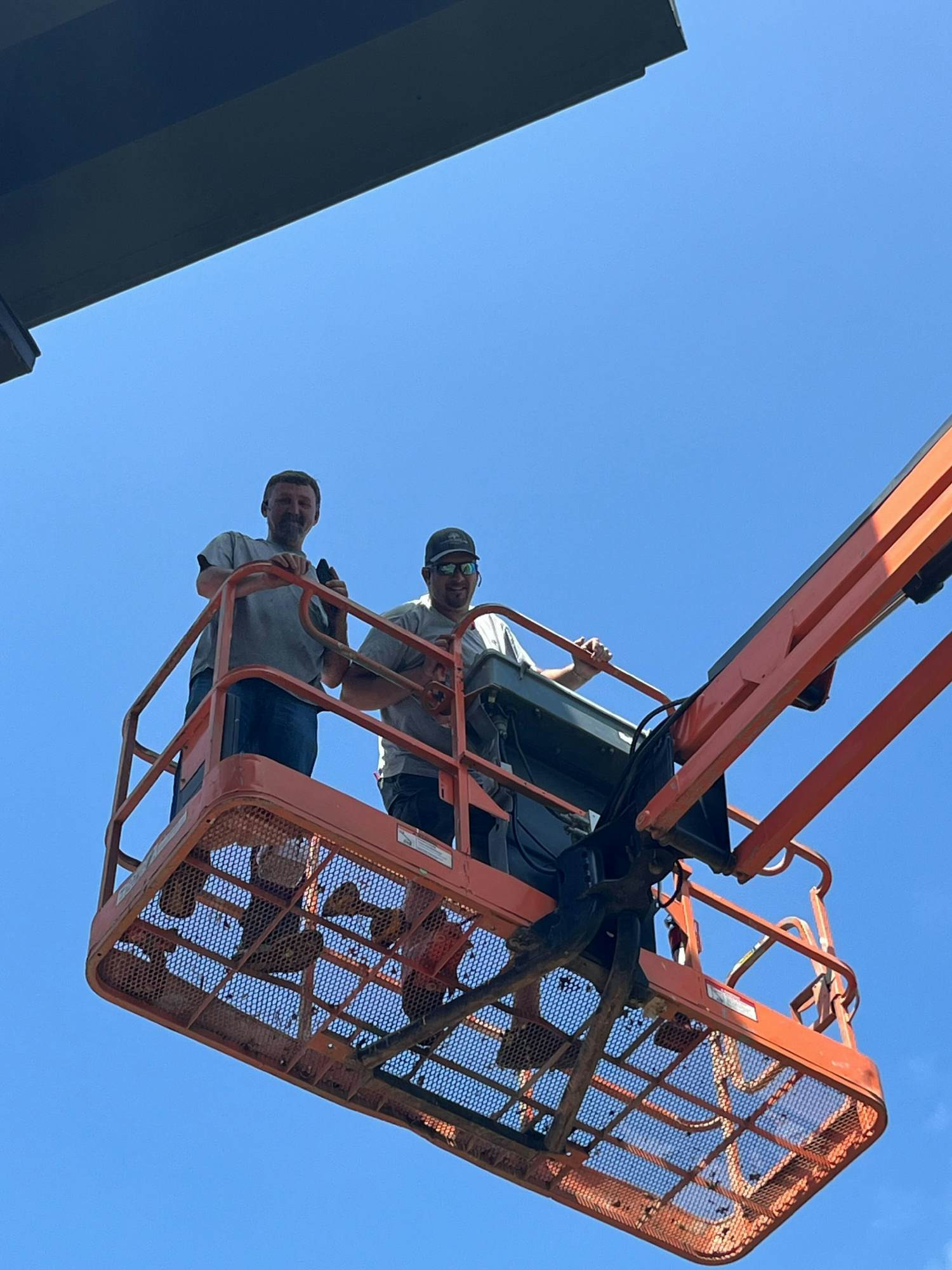 Our maintenance and construction managers hanging one of our property signs. 