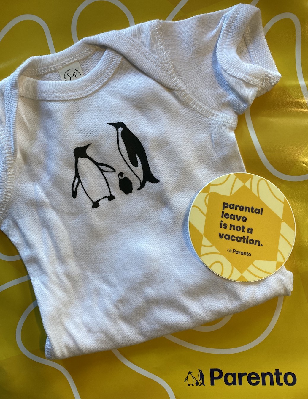 Parento sends care packages to parents on leave, including onesies, stickers, penguin plush, pins, teas, and more! 