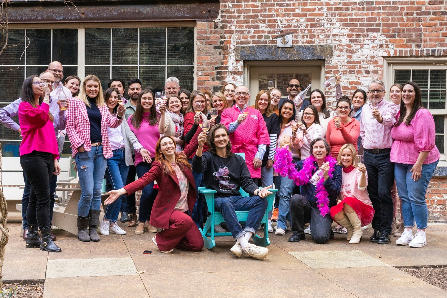 The team celebrating the launch of our new partnership with pink robes and pink bubbly!