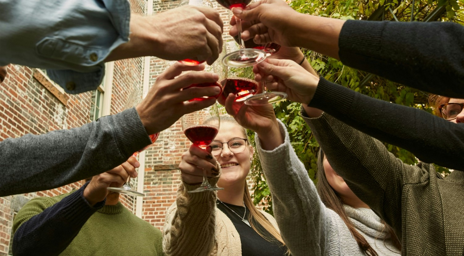 The team celebrating the launch of our new partnership with pink robes and pink bubbly!