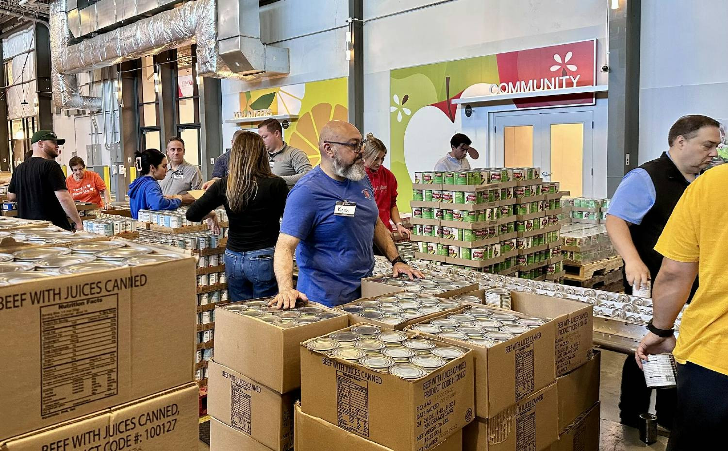 Connors Group Team Members packing more than 800 boxes to support local seniors.
