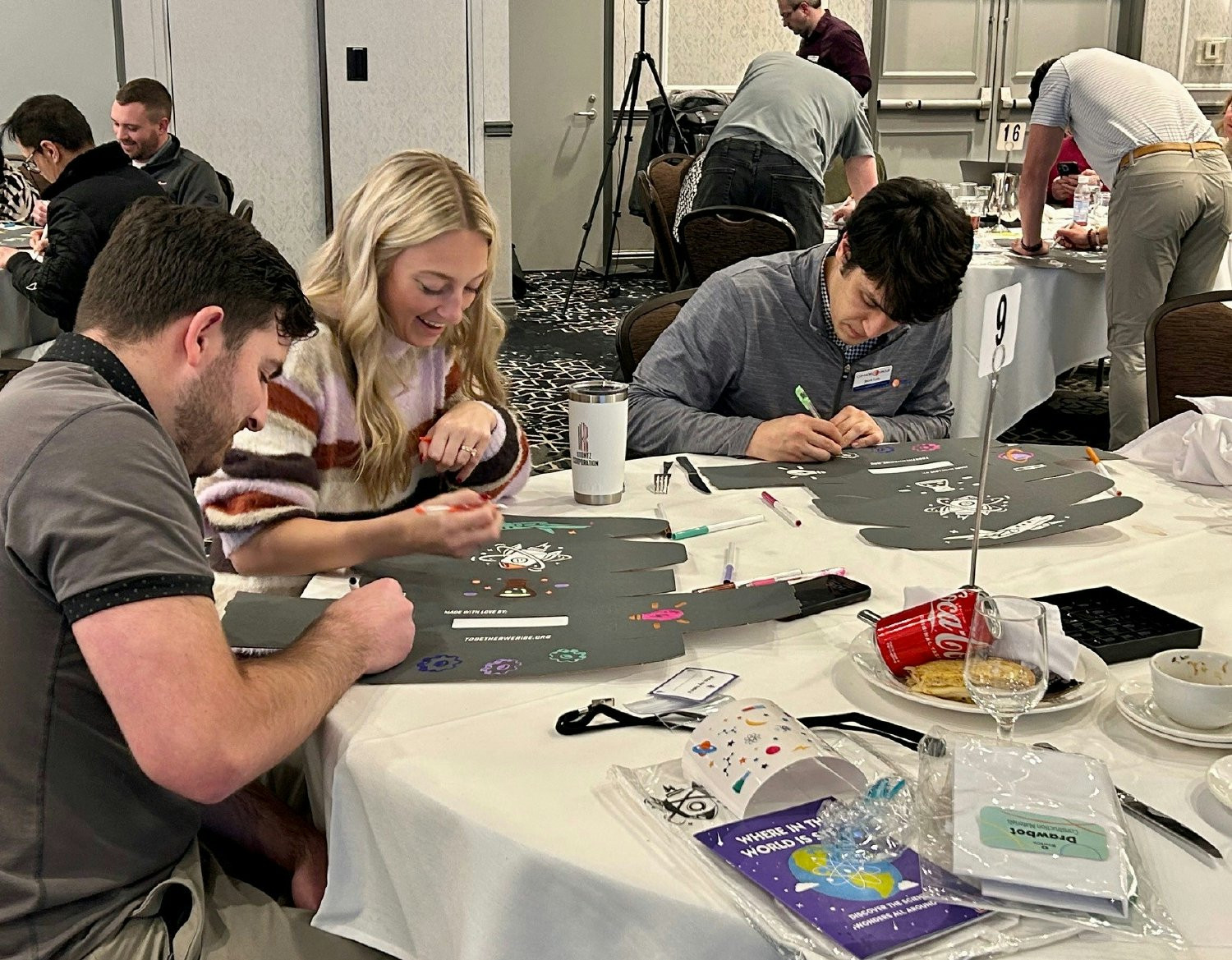 Connors Group Team Members assembling and decorating STEM boxes filled with activities for a Foster Love donation.