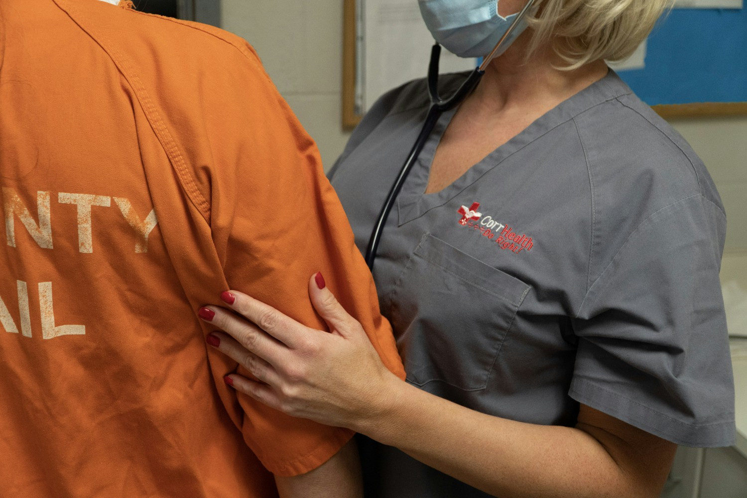 CorrHealth nurse checking inmate patient.
