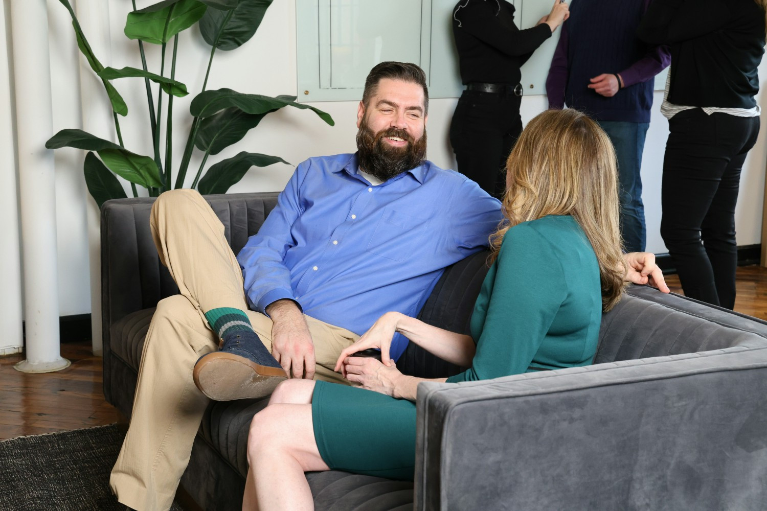 Burke and Michelle in conversation at a team meeting. 