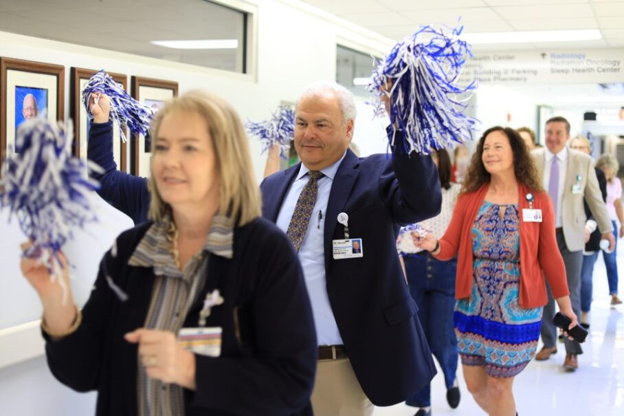 Senior leadership participates in the traditional jazz-band second line, reminding team members to always celebrate.