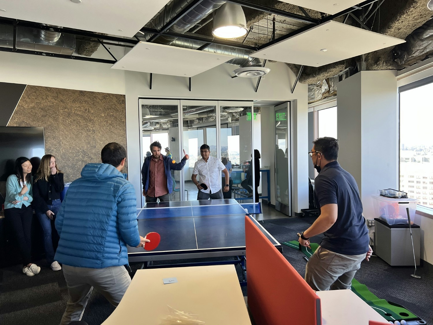 Ava team members playing ping pong in the office.