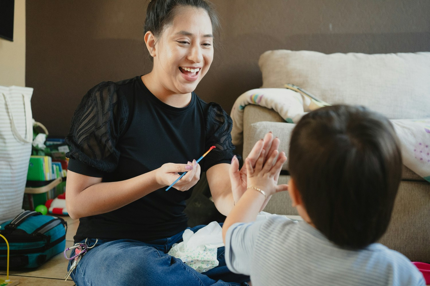 Employee interacting with child during homevisit.