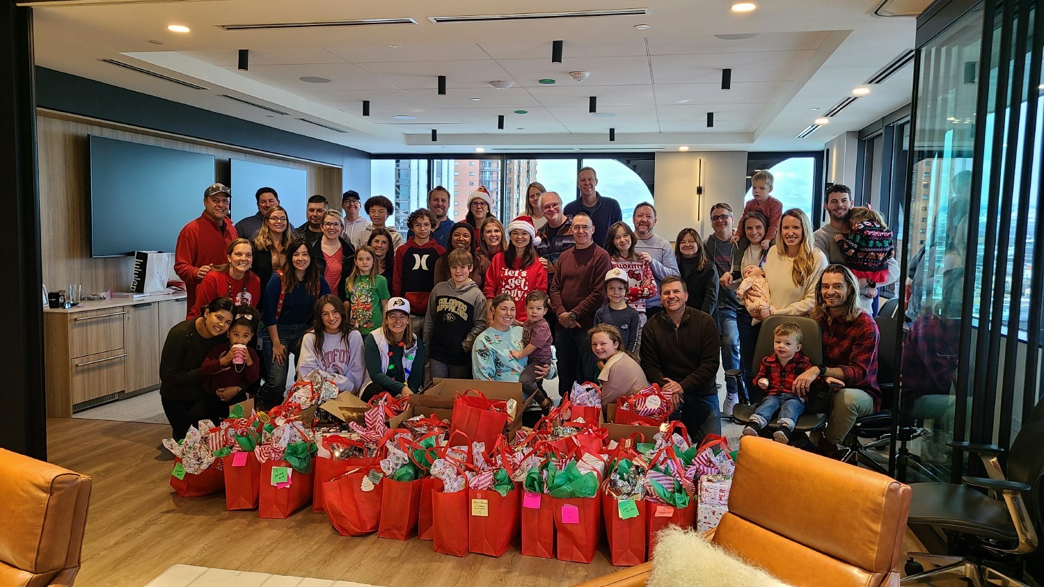 RevGeners and their families gathered in our office to wrap donated gifts for 59 children at a local elementary school.