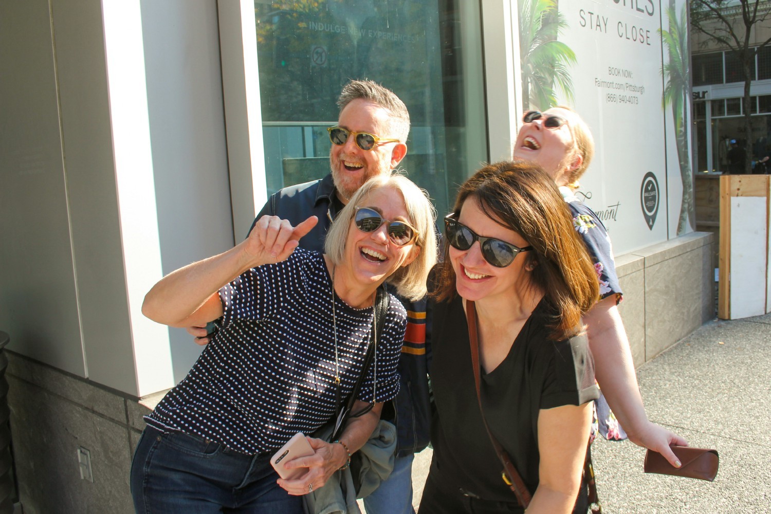 Employees laughing during a company-wide scavenger hunt in downtown Pittsburgh.