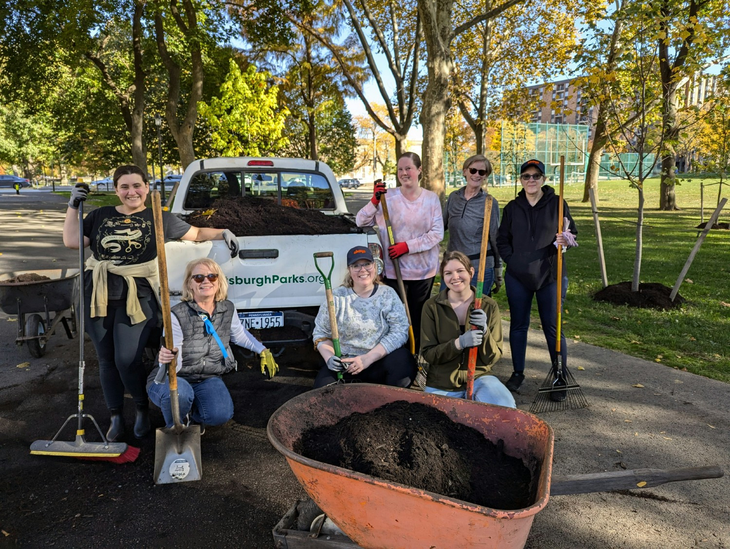 Employees volunteering to spread mulch around Allegheny Commons Park in Pittsburgh, PA.
