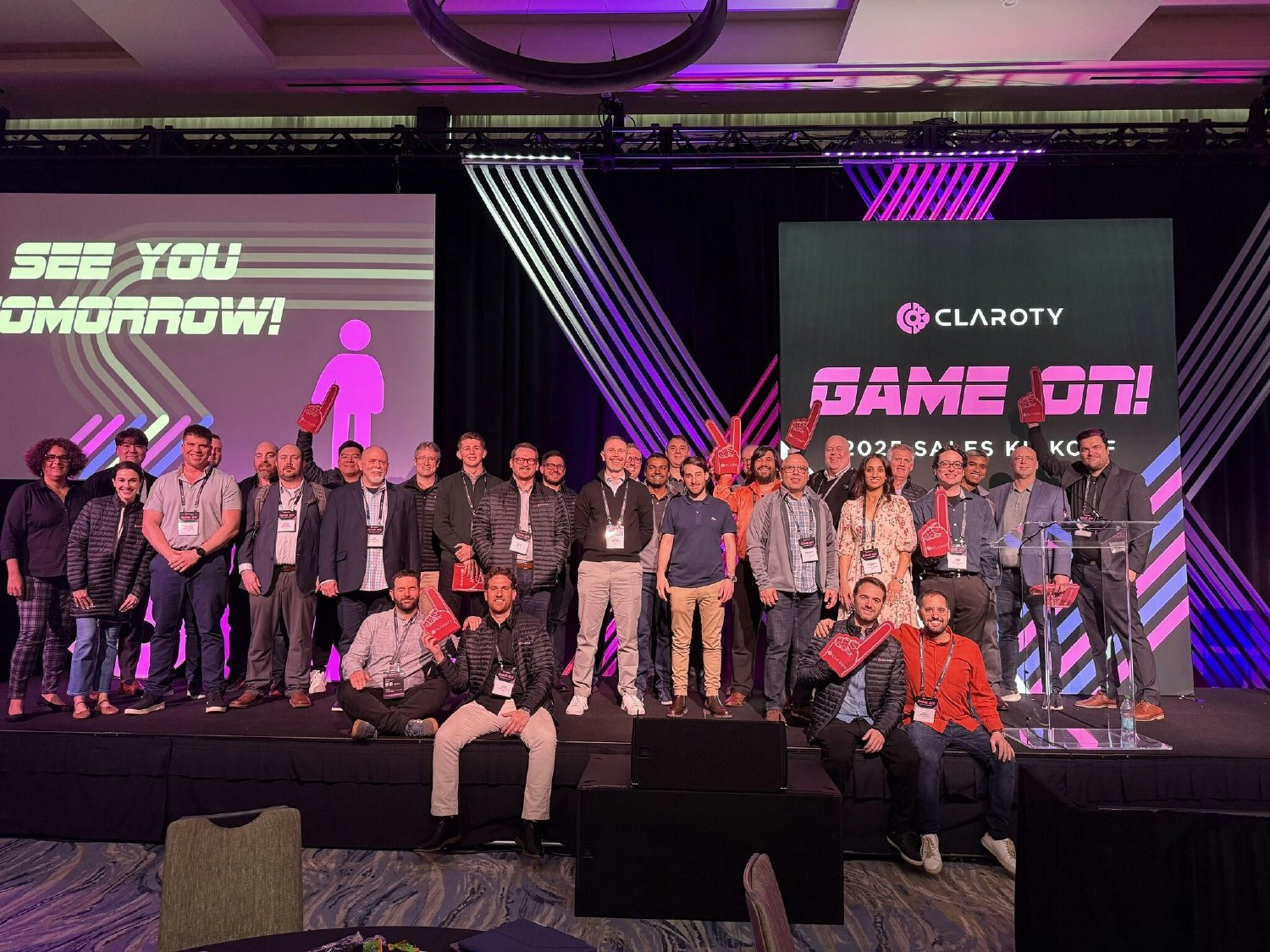 Game on! Team on stage at Sales Kick Off