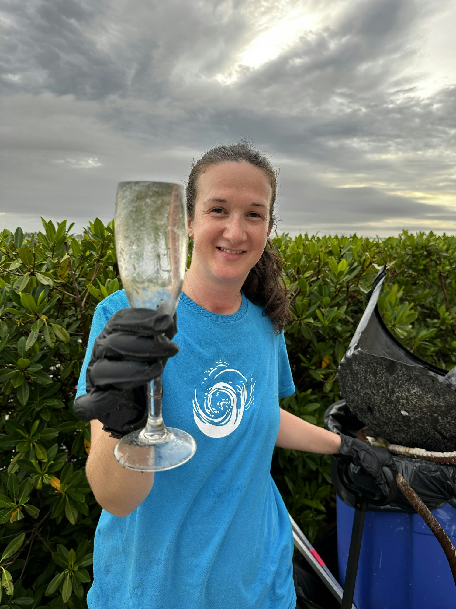 Ashley Mpanza, Owner Relations Manager, finding treasure during one of our our quarterly beach clean-ups.