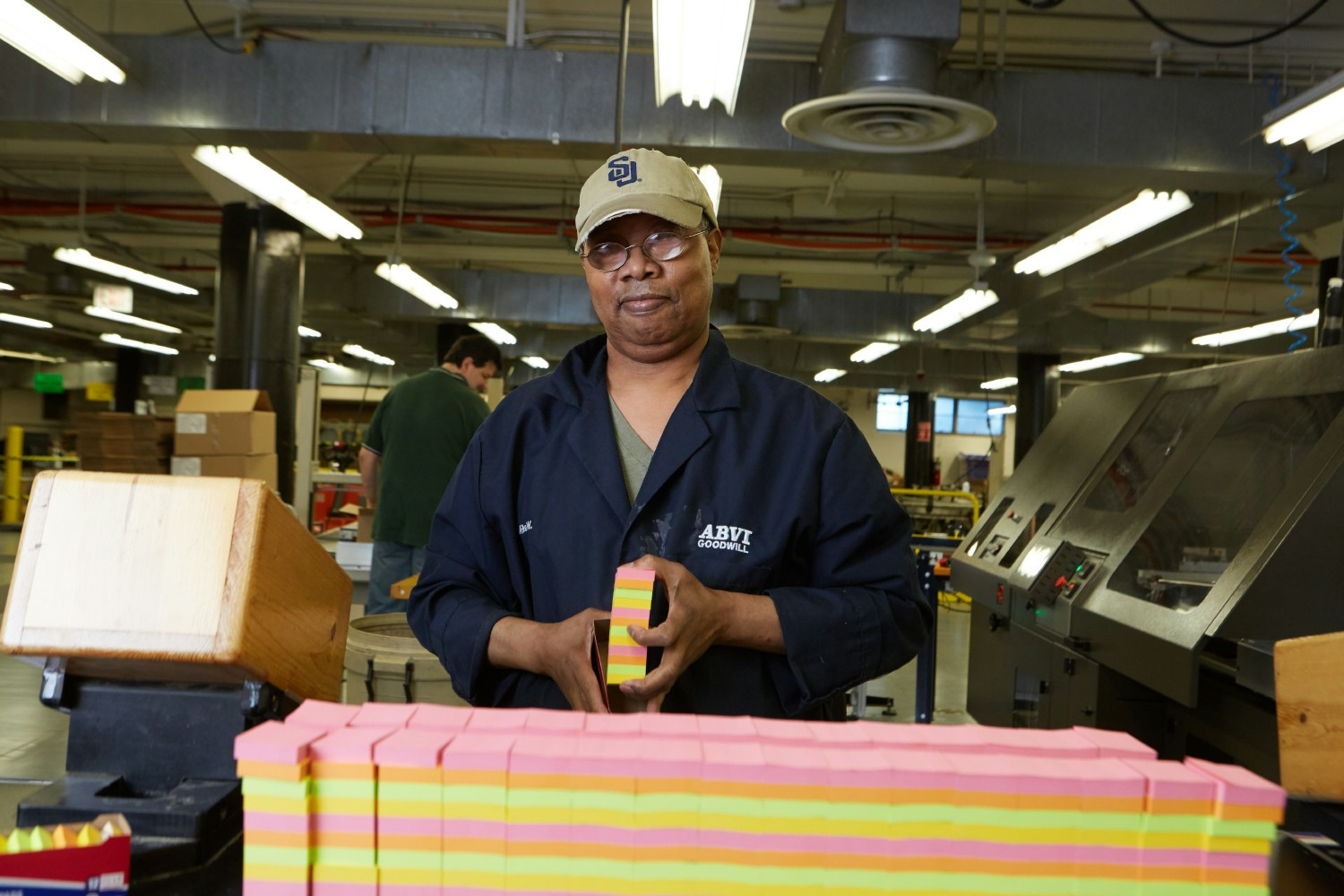 Manufacturing employee packaging sticky notes.