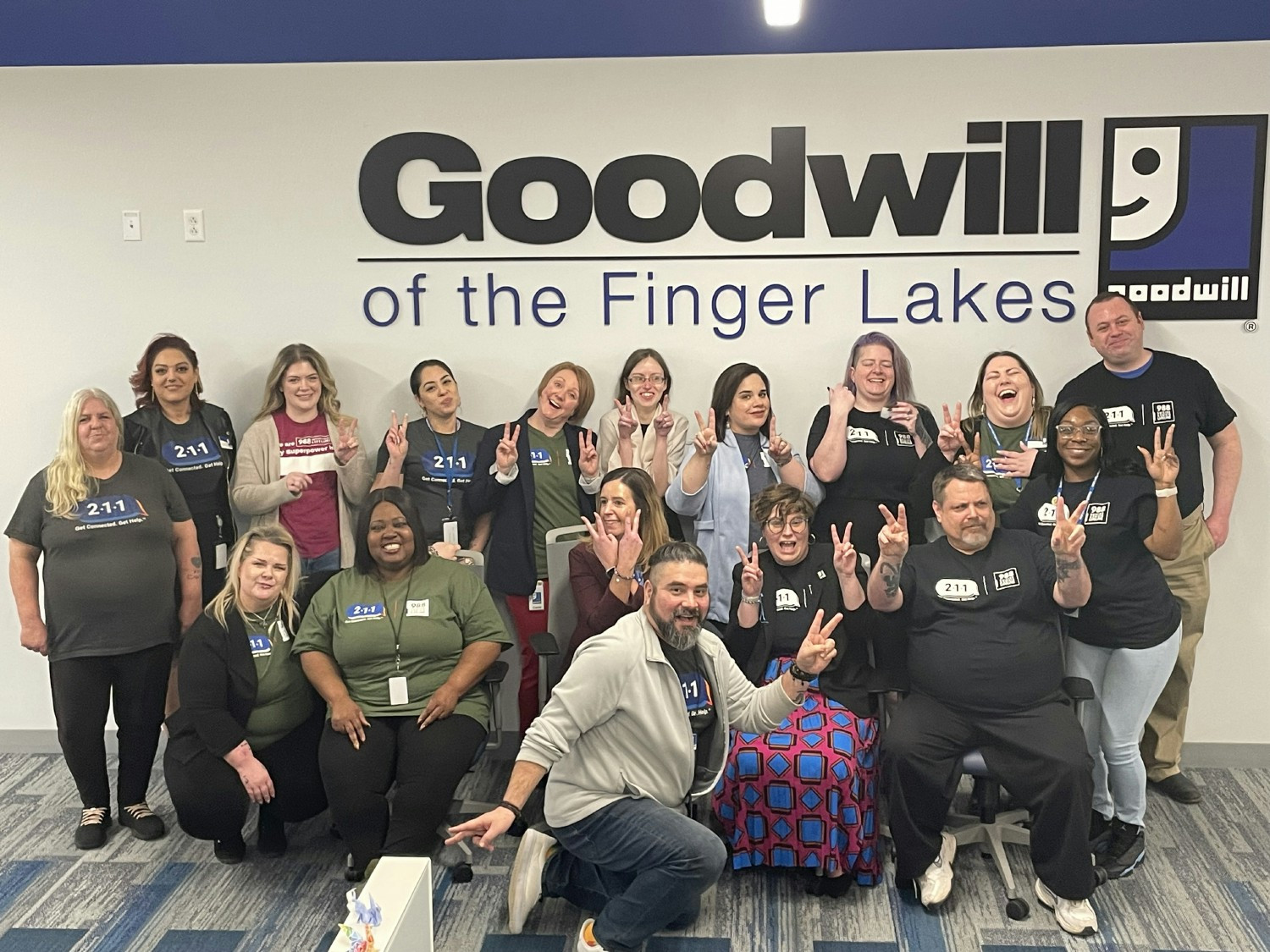 Employees gathered around our logo.