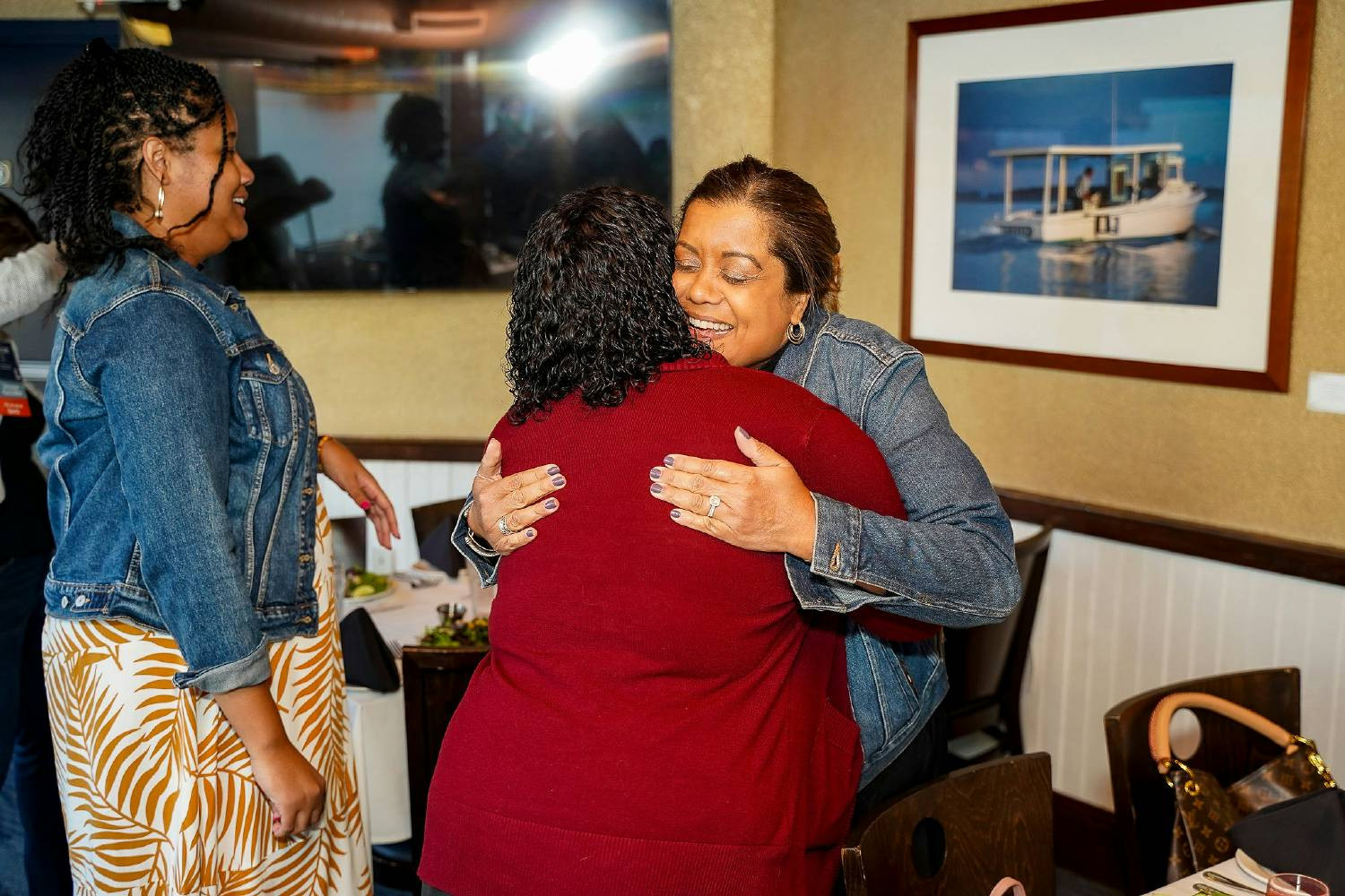LEE President Mildred Otero greets colleagues as they arrive at the All Staff Gathering