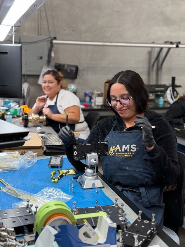 AMS Group employees working in manufacturing facility.