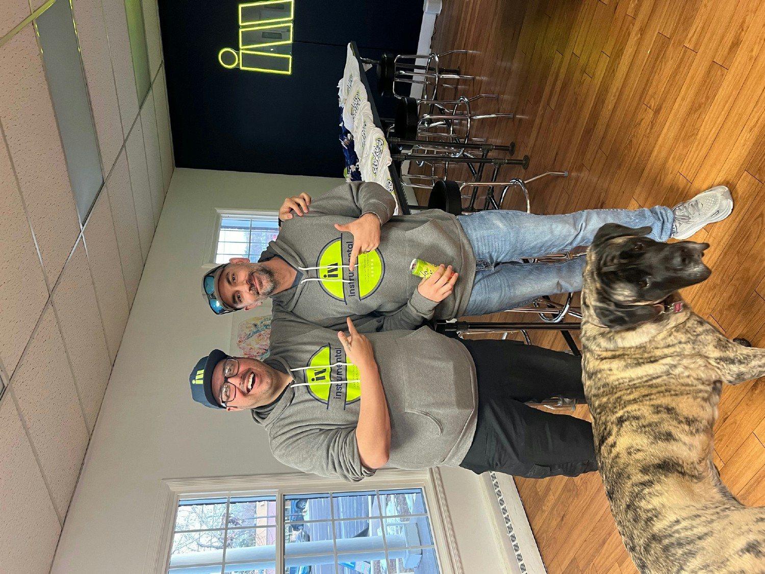 Instrumental Group staff pose for a picture in matching agency gear along with office dog Lucy.