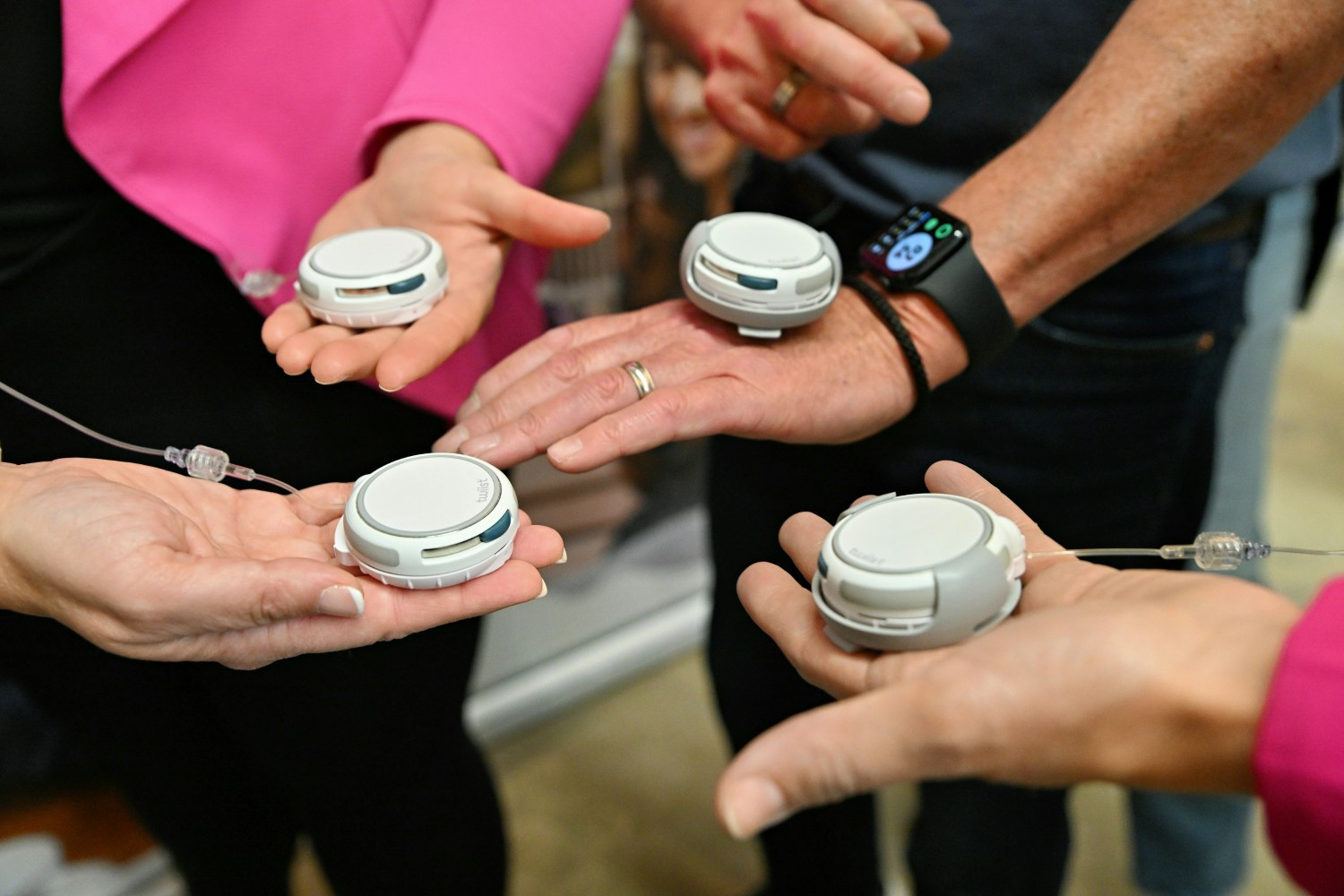 Employees gather to celebrate their first day wearing the twiist AID system.