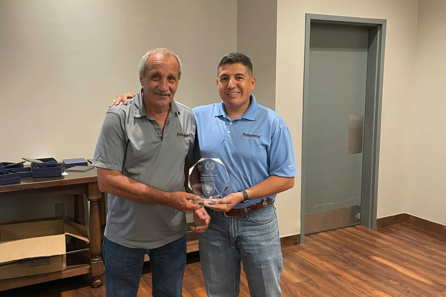 David Cheek, one of Falkenberg's longest-serving employees with 35 years of dedication, alongside President John Castro.