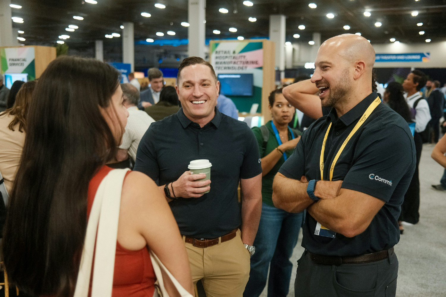 Ryan Herlihy (left) and Paul Stanton (right) chat with a customer at the Workday Rising conference.
