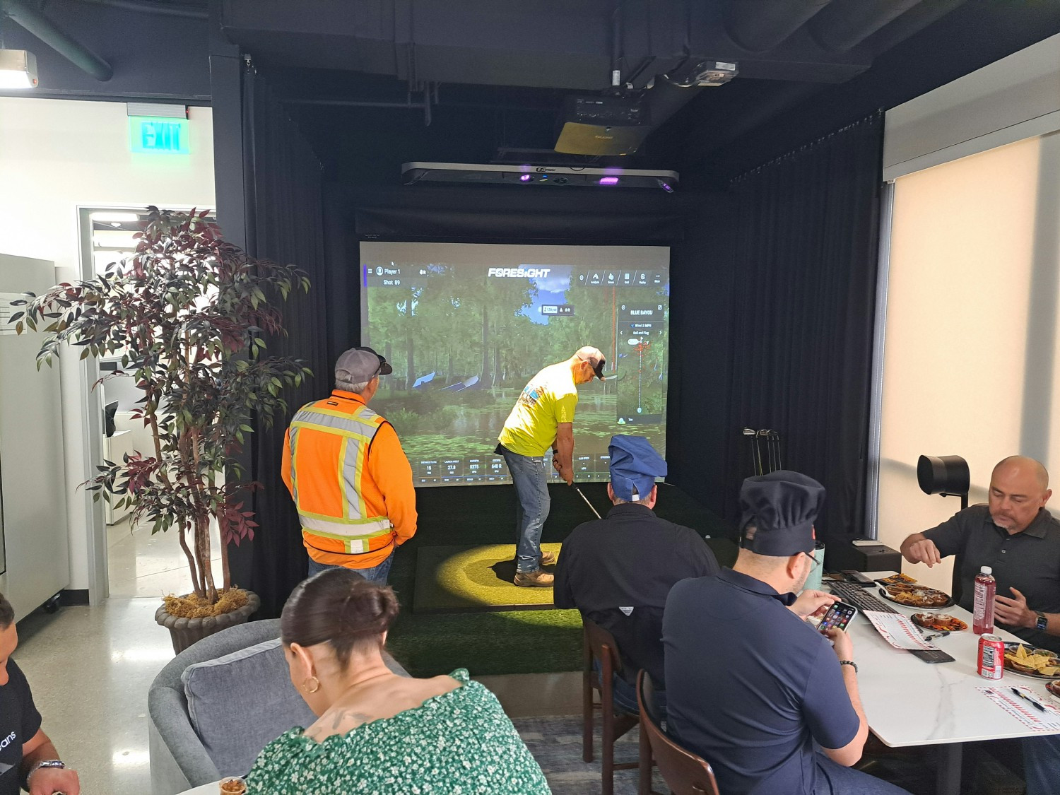 WLG staff having lunch, enjoying each other's company, and hitting golf balls in the Corporate Office. 